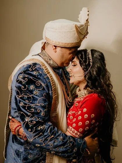 A tender embrace, full of warmth and affection. This intimate portrait feels like a quiet moment stolen away from the wedding buzz.