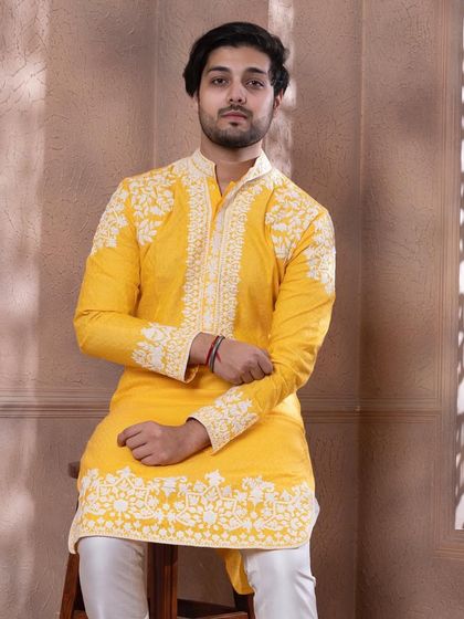 This seated shot shows the full scope of the embroidery on our zesty yellow kurta.