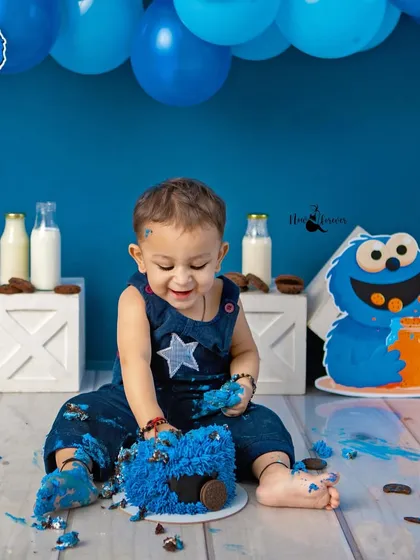 Digging into the cake with a happy grin. Cake smash sessions are all about letting kids be kids and capturing their genuine reactions.