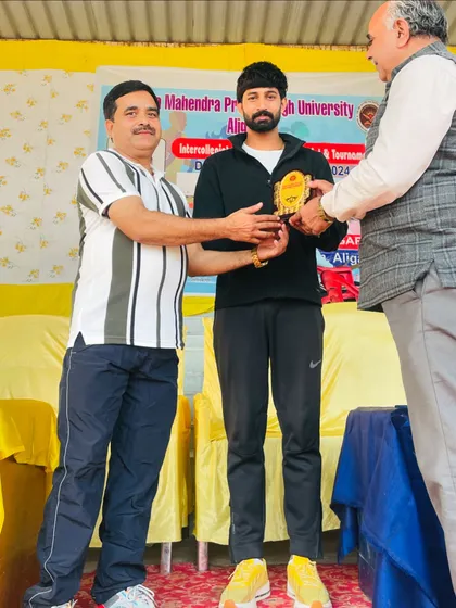 Receiving an award at Aligarh University. It is an honor to be recognized for my contribution to sports, and it motivates me to continue my work.
