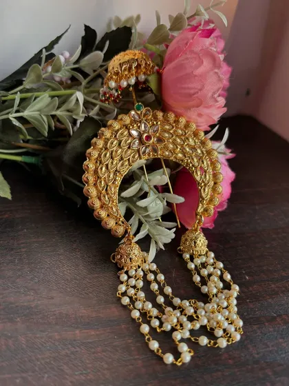 A styled shot of the 'Khopa' hair pin, ready to adorn a beautiful bridal hairstyle.