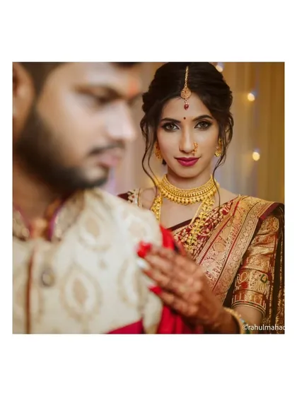 A creative portrait with the bride in focus, looking directly at the camera while her groom is softly blurred in the foreground. This adds depth and a unique perspective to the shot.