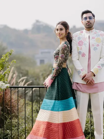 A full-length shot of Ria and her groom at their carnival event.