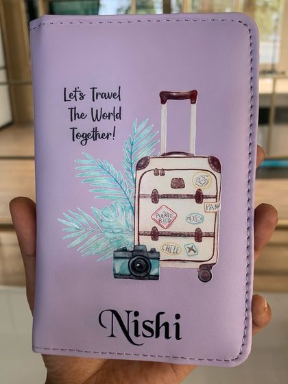 The matching personalized passport cover for 'Nishi', part of a travel-themed couple's gift set.
