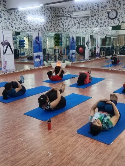 The class moves together into Pawanmuktasana (Wind-Relieving Pose). This simple pose is great for the digestive system and releasing the lower back, making it a favorite in our sessions.
