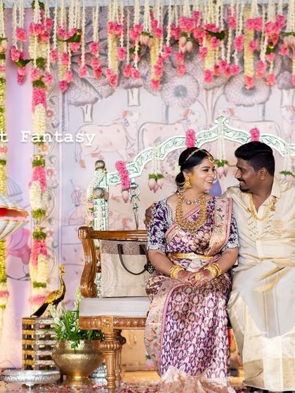 A sweet moment between the parents on the naming ceremony stage. The intricate floral work and traditional props create a setting that is both grand and intimate.