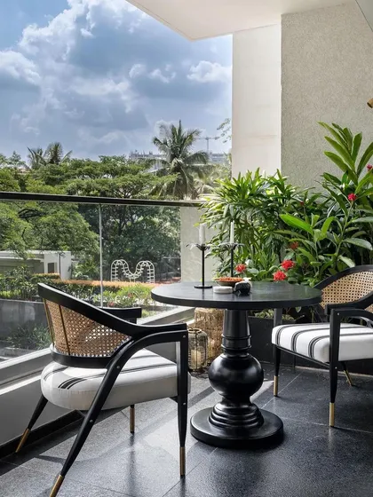 A charming balcony setup from the same AD-featured home, with our custom-made chairs. The design incorporates a classic caned back with a modern striped fabric seat.