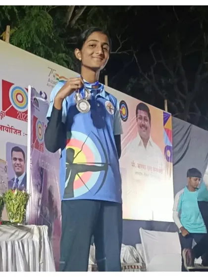 A student from our academy proudly displays her silver medals won at the U14 State Level Archery Competition. Her success qualified her for the national championship.