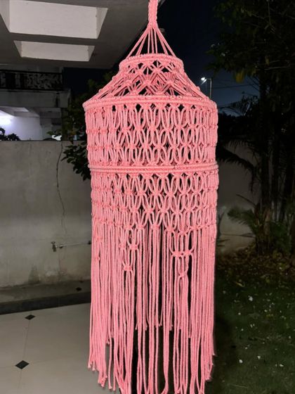 This pink macrame lantern features a different, more intricate knotting pattern. We have a variety of designs available for our lampshades to suit your decor style.
