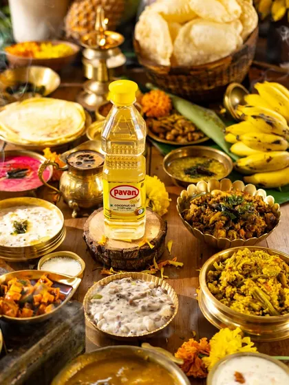 A vibrant, busy scene of an Onam sadhya, showcasing the abundance and variety of the feast. This is a great example of a maximalist food flat lay.