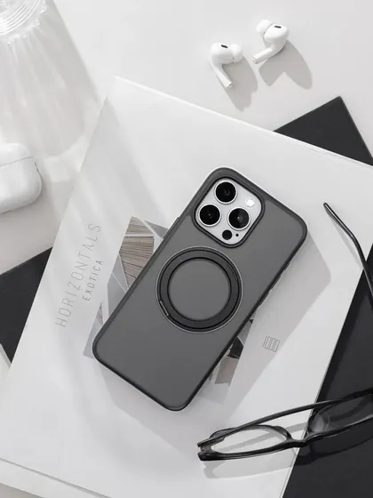 A clean, black and white themed flatlay for a phone case. We used a magazine, glasses, and AirPods to create a sophisticated, work-from-anywhere vibe.