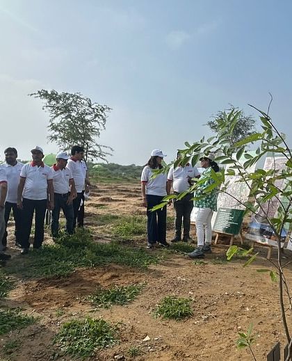 The Bry-Air team listens to a briefing before their plantation drive, learning about the specific native species they will be planting and their importance.
