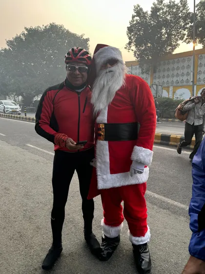 A member of our club posing with one of our Santas during the Christmas ride.