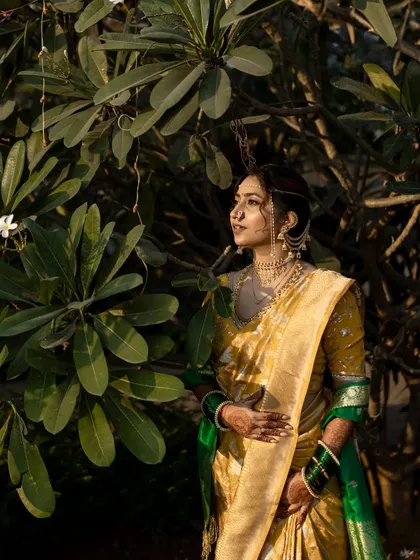 A serene portrait of the bride amidst lush greenery, looking thoughtful and elegant.