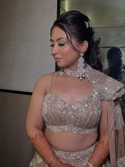 A side profile of the bride, highlighting the beautiful contouring and the intricate details of her outfit.