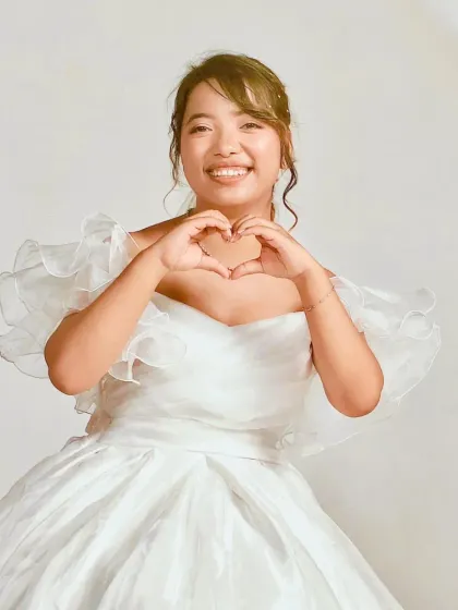 A joyful shot featuring our white ball gown. The off-the-shoulder neckline perfectly frames the face for beautiful close-up portraits.