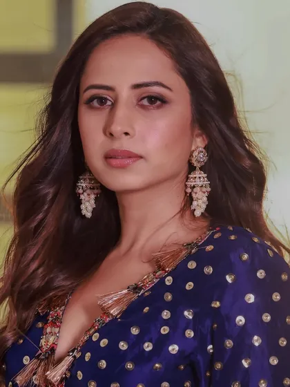 Sargun Mehta looking elegant in a royal blue outfit, perfectly accessorized with our handcrafted pearl jhumkas.