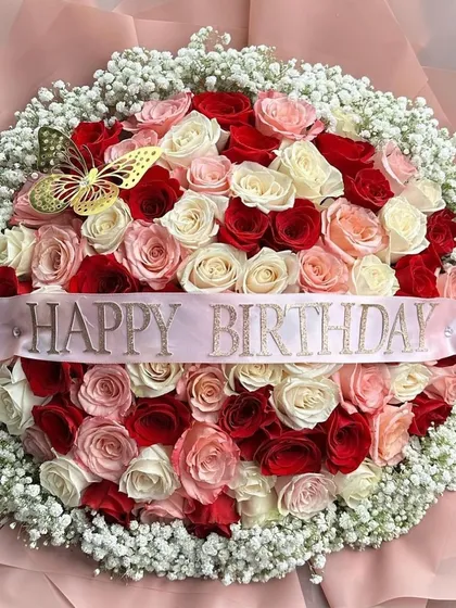 A close-up of our grand birthday bouquet, showing the beautiful texture and color variation of the roses. The golden butterfly accent adds a whimsical touch.
