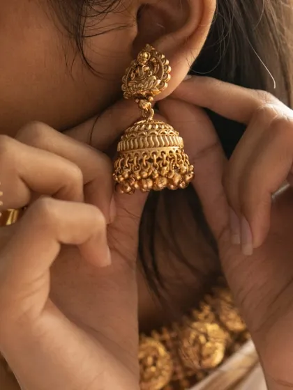 A detailed shot focusing on the temple jhumka and the matching statement ring. Every piece in the set is crafted with the same attention to detail.