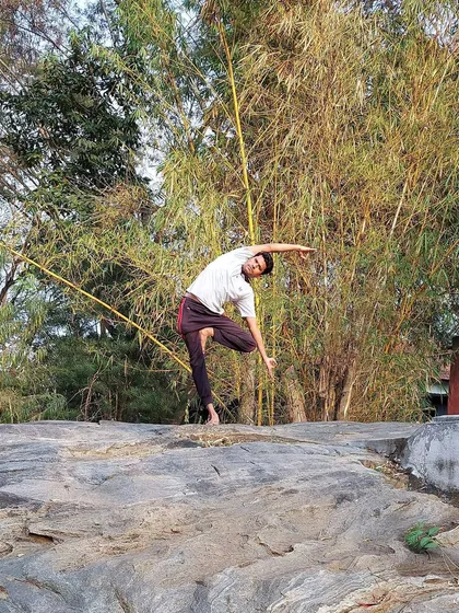 This variation of a standing side bend on an uneven surface challenges our balance and stability. Such postures increase the flow of 'prana', or life force energy, by removing blockages along the spine and invigorating the entire body.