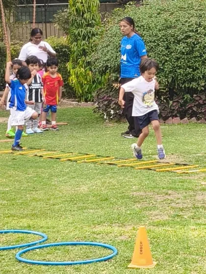 A young player navigates an agility ladder during a First Kicks session. These drills are designed to improve footwork and coordination in a fun, engaging way.