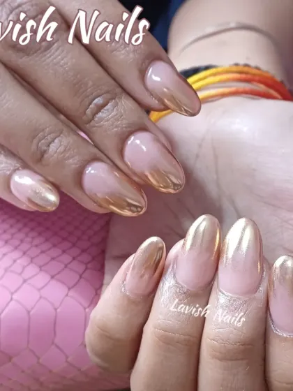 This set showcases a stunning gold chrome ombre effect on long, almond-shaped nails. The metallic gold polish fades beautifully into a natural nude base, offering a sleek, modern, and highly polished finish.