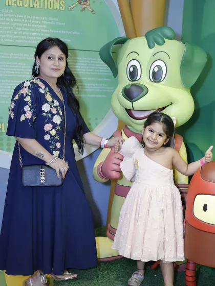 A mother and daughter share a sweet moment, posing with our mascots during their visit.