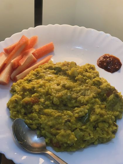 A comforting plate of homemade khichdi with a side of carrots. This is the kind of simple, nourishing 'ghar ka khana' that forms the foundation of my diet.