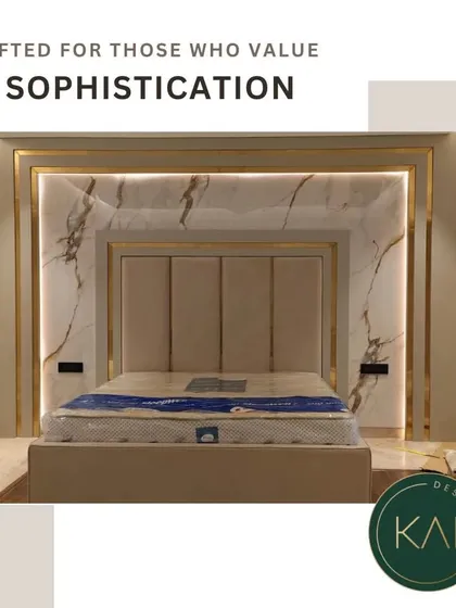 Elevate your bedroom into a luxurious retreat with our integrated design approach. This bespoke bed features a tall, panelled headboard set against a stunning marble wall with backlit gold accents, creating a dramatic and opulent focal point.