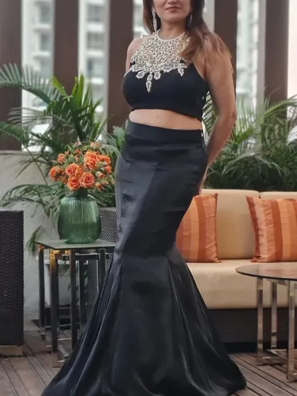 Here I am in a classic black mermaid skirt paired with a stunning crystal-embellished crop top. This outfit is versatile and can be styled in three different ways, making it a great addition to your party wardrobe.