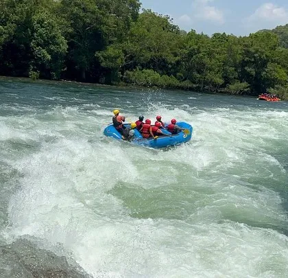 Riding the waves on the Kali River, this shot captures the dynamic movement of the raft and the beautiful, lush scenery of Dandeli.