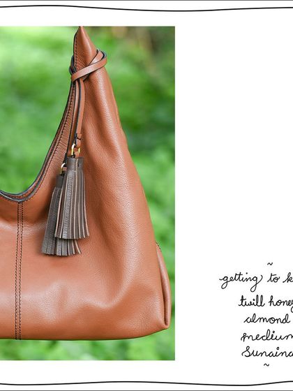 A detail shot of the Twill Honey Almond Medium Sunaina, showing the contrasting Oak brown tassels and twill-woven handle.