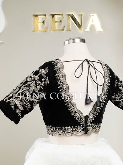 For a chic and contemporary look, I designed this black velvet blouse. It features intricate silver floral embroidery along the scalloped neckline and sleeves, creating a stunning contrast that is perfect for any special occasion.