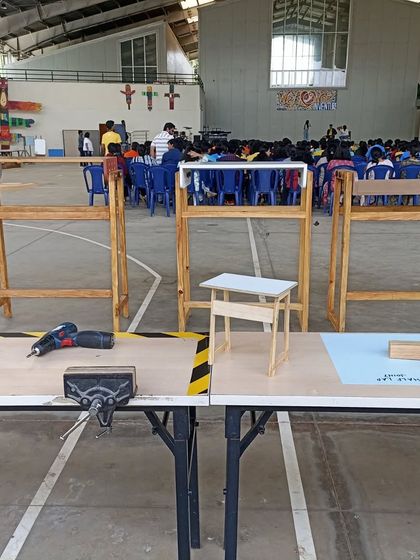 The standing desks on display in a large hall. This was part of a 10-session program where students in grades 9 to 12 built their own furniture.