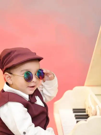 A stylish little pianist in a maroon vest and cap. We have a variety of outfits to perfectly match our creative themes.