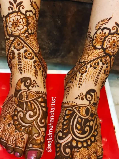 An elegant feet design centered around graceful peacock motifs. The pattern flows beautifully along the natural curve of the foot, adorned with delicate floral vines.