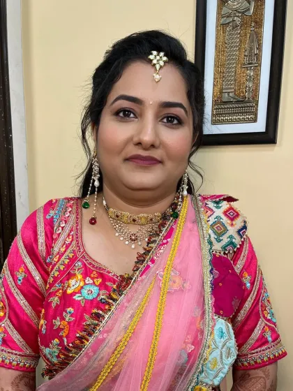 A close-up of the client's makeup, showing the flawless base and the subtle shimmer on her eyes.