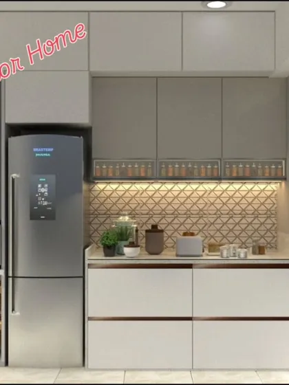 This kitchen design cleverly incorporates a washing machine and microwave unit alongside the refrigerator, showcasing our expertise in space-saving solutions for Mumbai apartments.