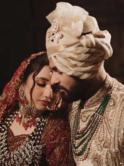 A close-up of the couple, highlighting the bride's intricate jewellery and the groom's serene expression.