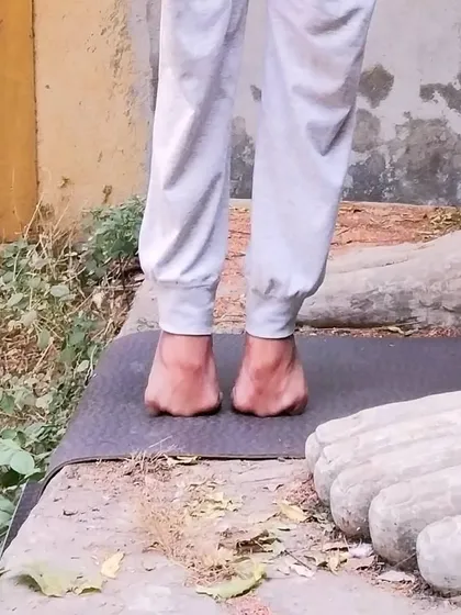 A close-up view of the folded-toe balance, highlighting the engagement required in the feet. Regular practice of such foundational exercises is key to preventing injuries and improving overall balance in your yoga practice.