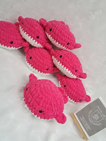 A group of the pink whale soft toys, ready to be packed for a birthday party.
