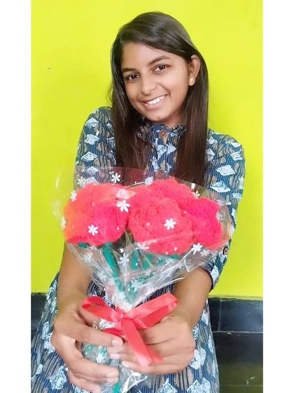 Me, proudly holding a finished bouquet of red roses.