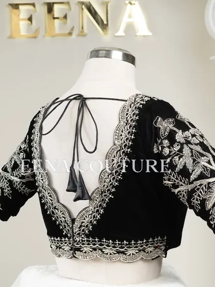For a chic and contemporary look, I designed this black velvet blouse. It features intricate silver floral embroidery along the scalloped neckline and sleeves, creating a stunning contrast that is perfect for any special occasion.