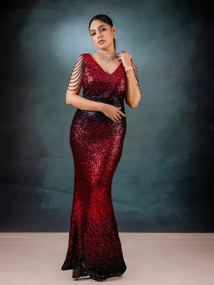 For moments that demand glamour, I designed this red and black ombré sequin gown. The mermaid silhouette is crafted to celebrate your curves, while the draped pearl shoulder details add a touch of modern royalty.