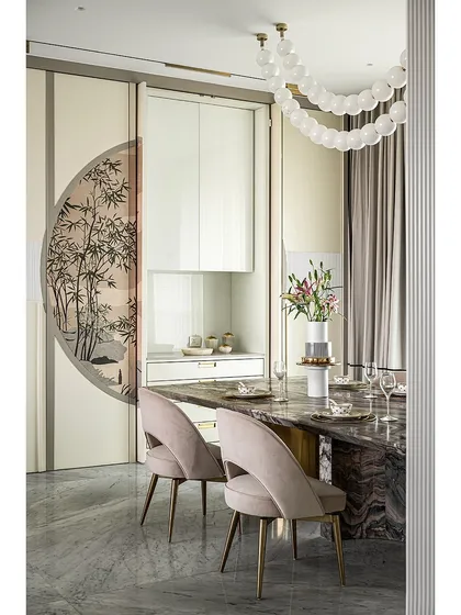 The pocket shutters in this dining room are not just for storage; they are a canvas for art. When closed, the veneer marquetry forms a complete picture. When open, they reveal a fully equipped crockery unit, blending beauty with utility.
