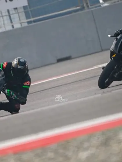 Two riders battle for position, leaning in unison as they navigate a turn. This image captures the close quarters racing and competitive spirit of our track days.