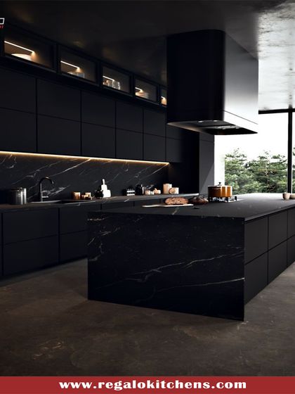 The ultimate in dramatic design, this all-black kitchen features a stunning black marble island that commands attention. We integrated the chimney and cabinetry to create a seamless, powerful look, perfect for a home that values bold, contemporary aesthetics.