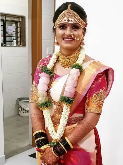 Here is the complete traditional bridal look. I handled the makeup, the hair with the matha patti setting, and the Kanjeevaram saree draping to create a cohesive and elegant style for her big day.