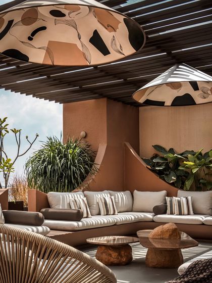 A closer look at the custom pendant lights and the organic shape of the built-in sofa. The design focuses on bespoke elements that make the space truly unique.