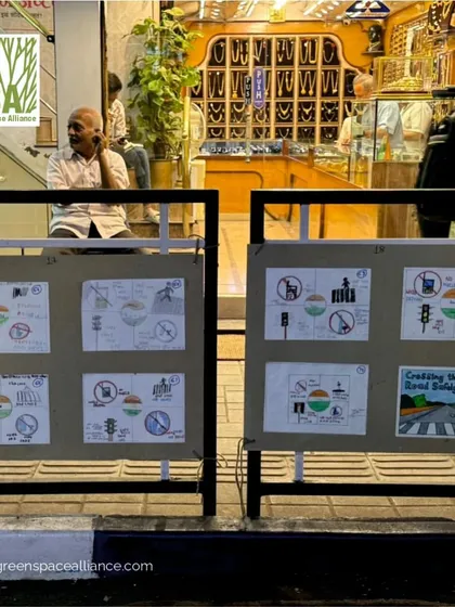 Children's drawings about road safety displayed during Pune's Pedestrian Day. Engaging the youngest members of the community is crucial for building a long-term culture of safe and walkable streets, a goal we champion in our urban design work.